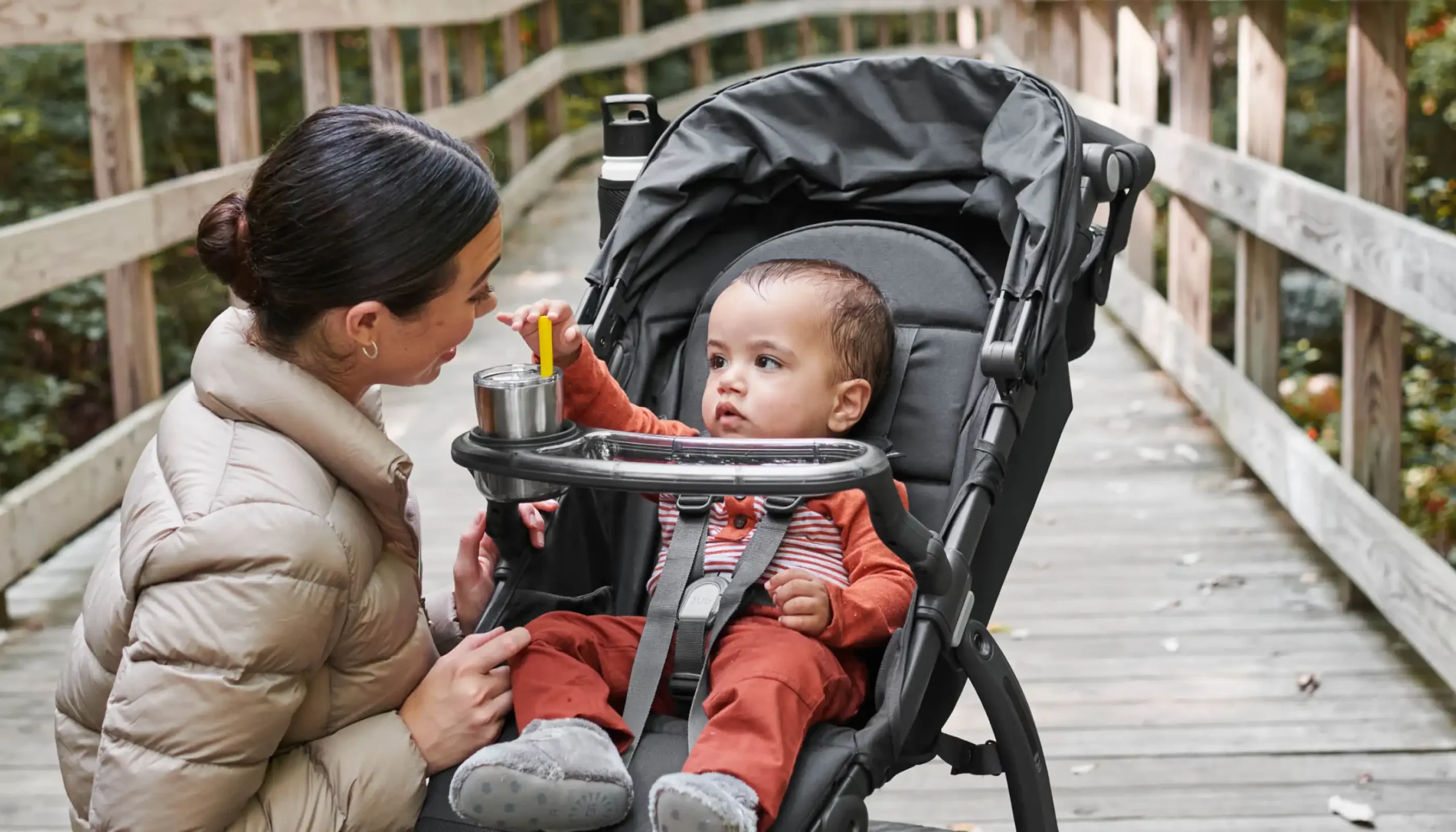 Parent looking at child in Ridge with Snack Tray