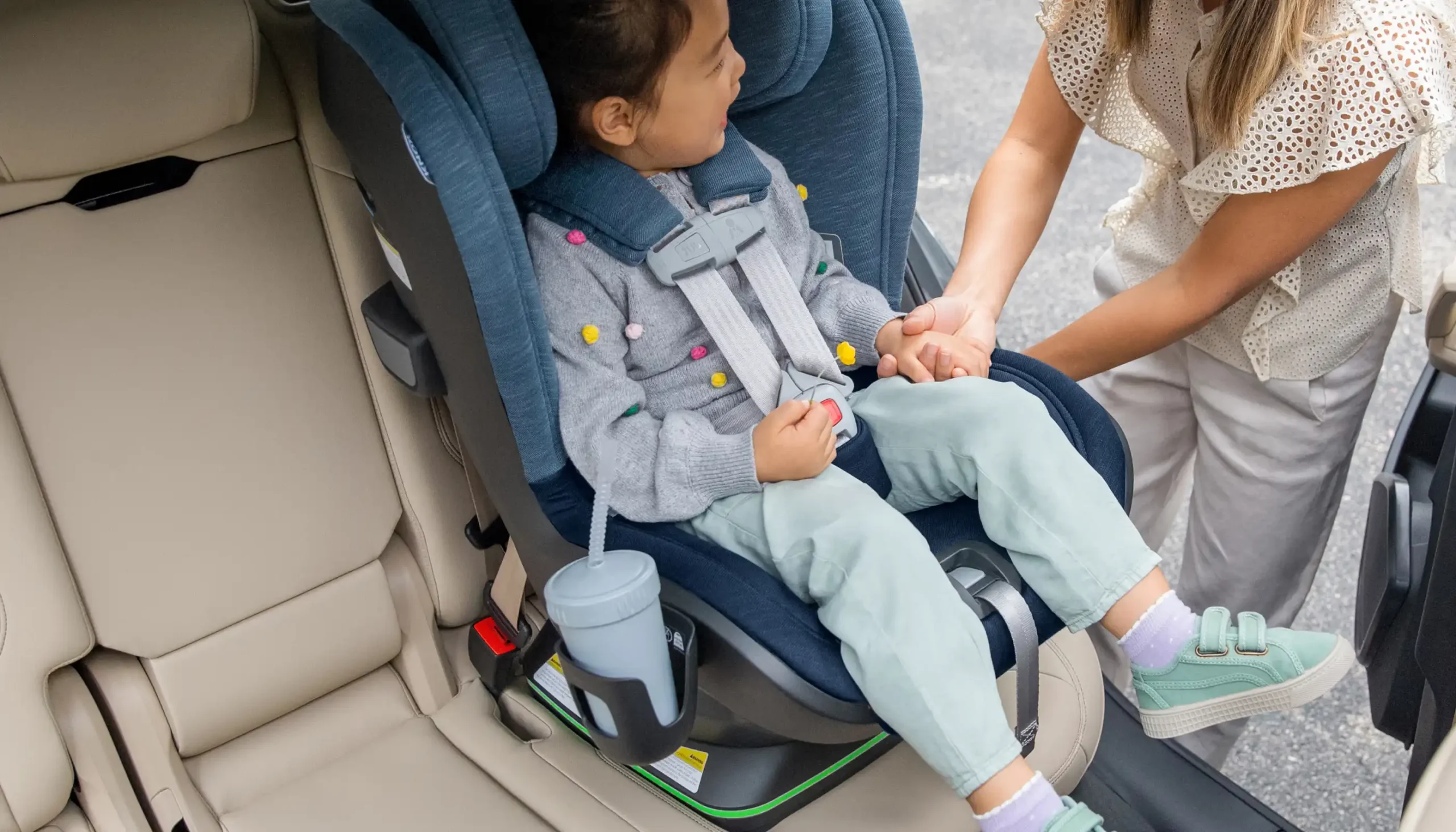 Child sitting in Knox with bottle in Cup Holder