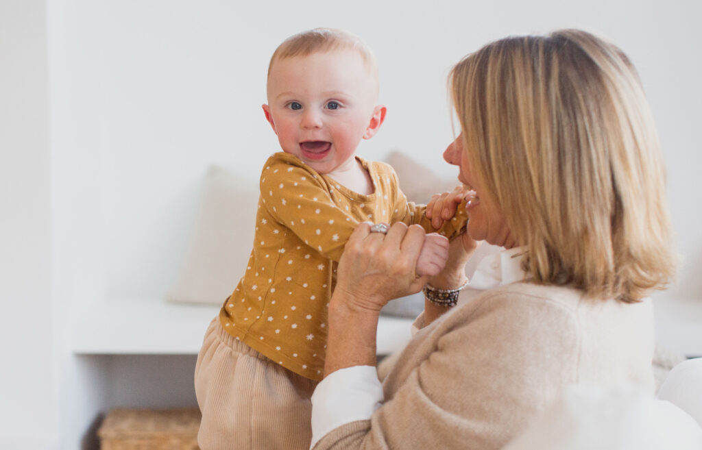 A grandmother and her little one laughing together.