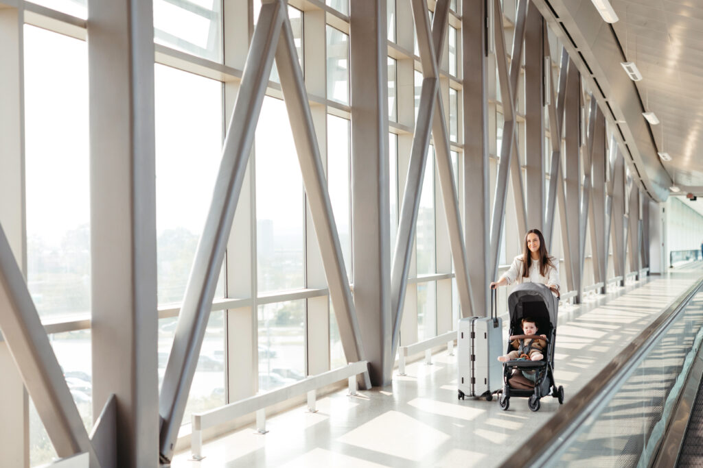 UPPAbaby Minu V2 stroller in use at an airport, demonstrating the travel-friendly design for active families on the move